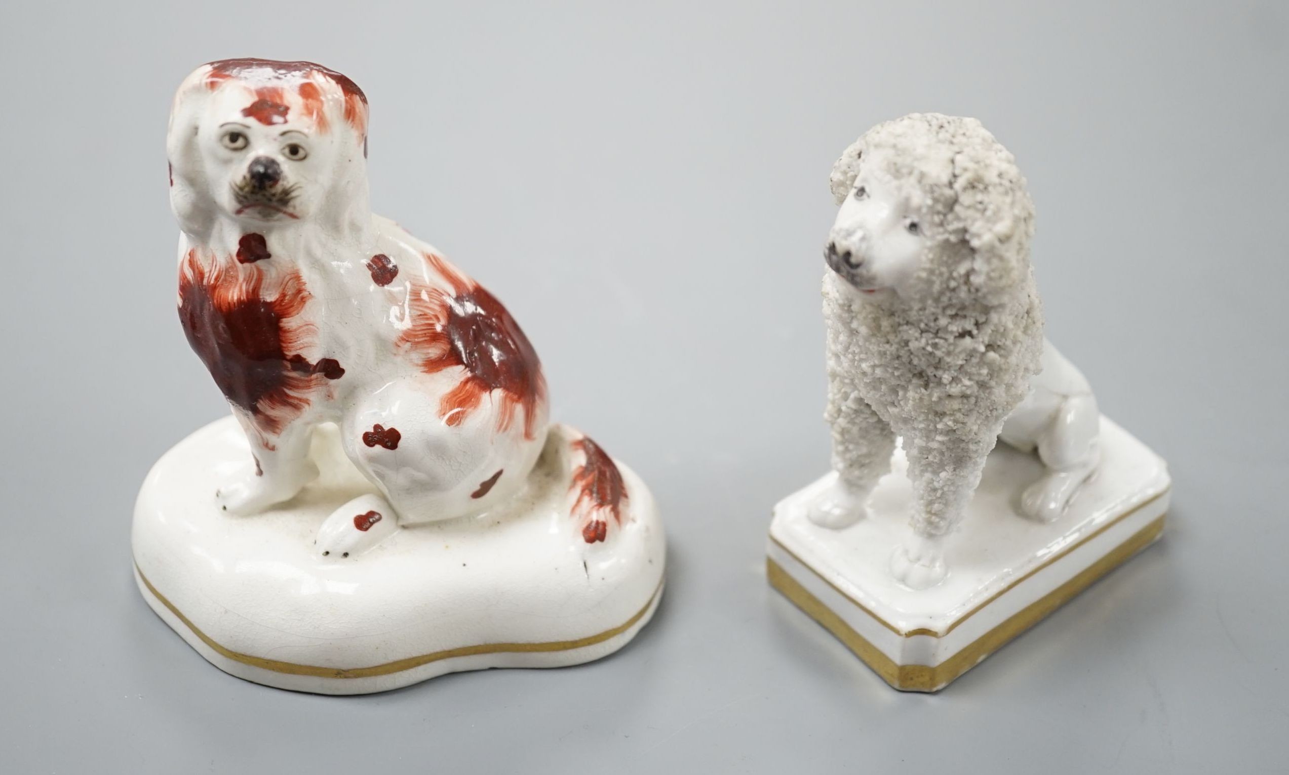 An unusual Staffordshire porcelain model of a seated poodle, 8.8cm high and a similar porcelain model of a seated King Charles Spaniel, c.1835-50, impressed mark ‘H’, Cf. Dennis G.Rice Dogs in English porcelain, colour p